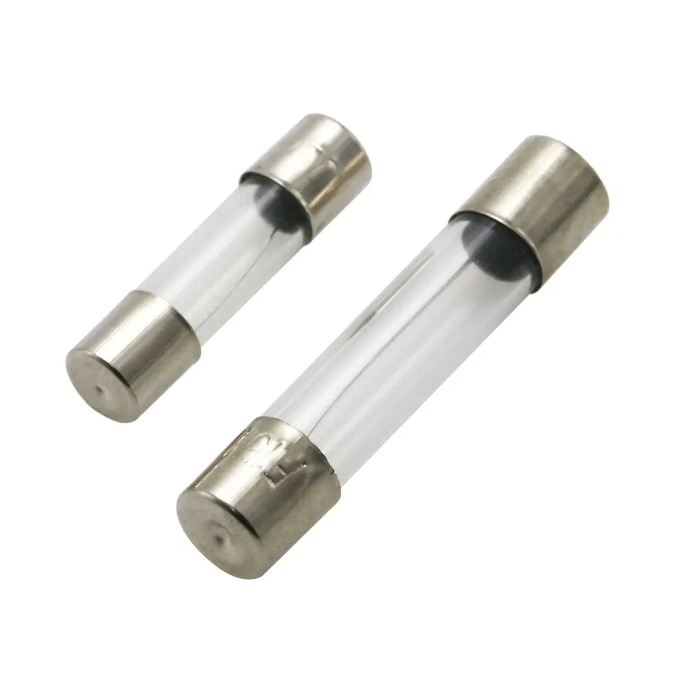 Two cylindrical fuses with metallic ends on a white background